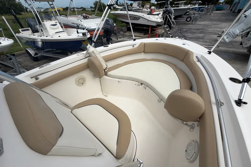 Slide: The Image of 2020 Pioneer 202 Islander boat with beige seating, docked among other boats. - 9