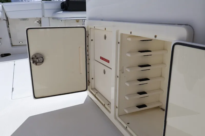 Slide: The Image of Open storage compartment on a 2006 Jupiter 38 HFS boat, showcasing organized shelving. - 38
