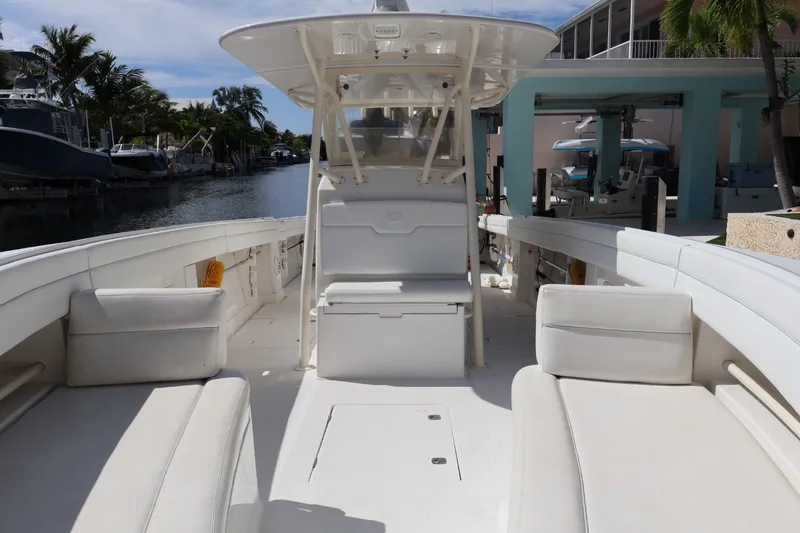 Slide: The Image of 2006 Jupiter 38 HFS boat interior with white seating, docked by a canal. - 34