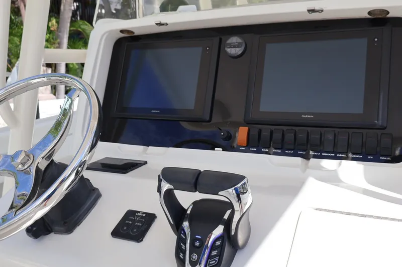 Slide: The Image of Helm of 2006 Jupiter 38 HFS boat with dual Garmin displays and steering wheel. - 30