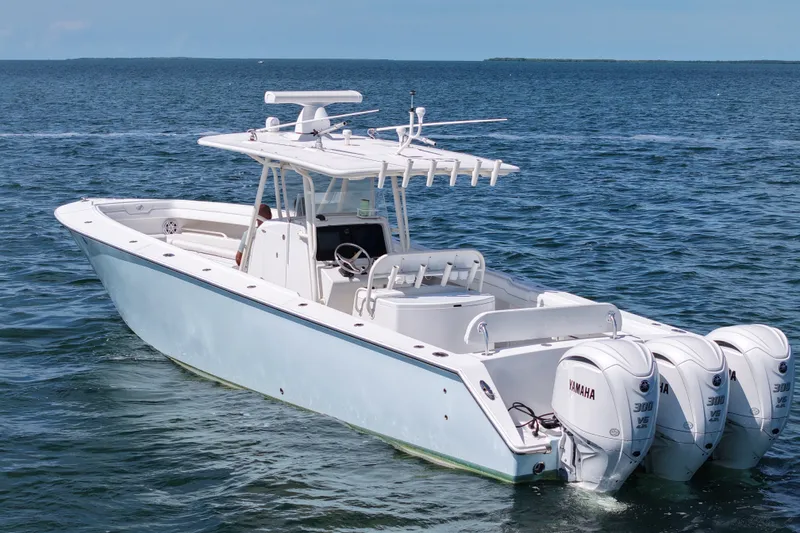 The Image of 2006 Jupiter 38 HFS boat with triple Yamaha engines on open water. - 1