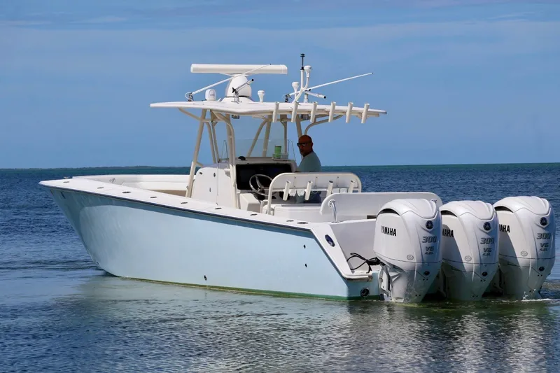 Slide: The Image of 2006 Jupiter 38 HFS boat with triple Yamaha engines on calm water. - 23
