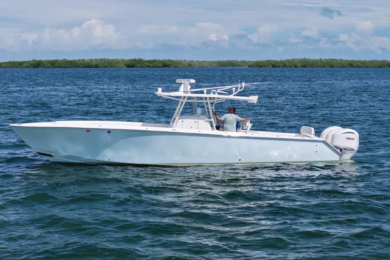 Slide: The Image of 2006 Jupiter 38 HFS boat on calm blue water with Yamaha engines. - 25