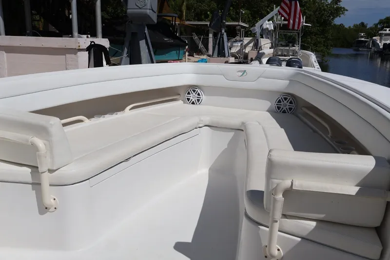 Slide: The Image of 2006 Jupiter 38 HFS boat interior with white seating and speaker system. - 36