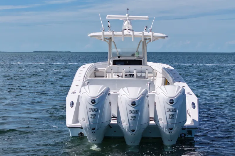 Slide: The Image of 2006 Jupiter 38 HFS boat with triple 300 V6 engines on open water. - 2