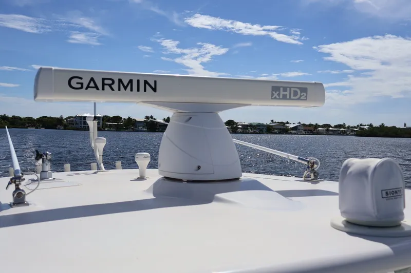Slide: The Image of Garmin xHD2 radar on 2006 Jupiter 38 HFS boat, with scenic waterfront background. - 39