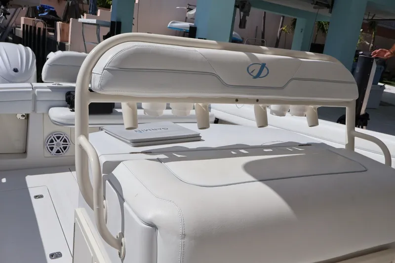 Slide: The Image of 2006 Jupiter 38 HFS boat interior with white seating and rod holders. - 31