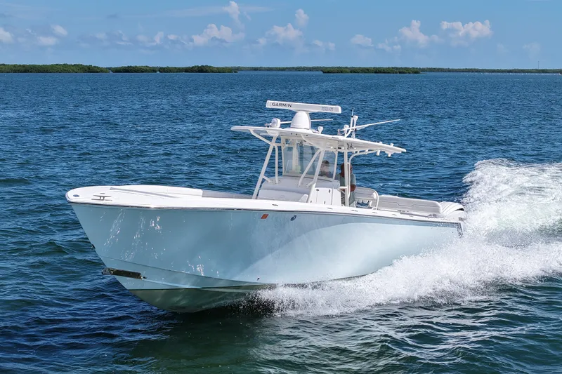 Slide: The Image of 2006 Jupiter 38 HFS boat cruising on open water under clear skies. - 24