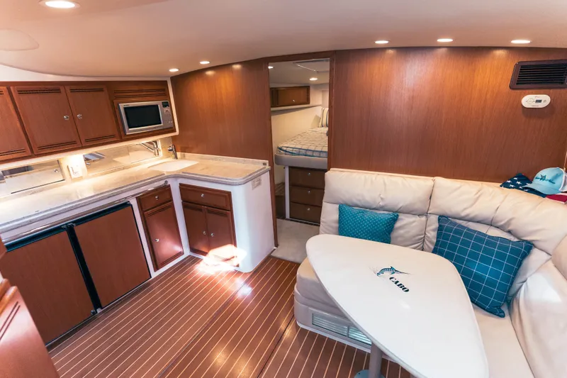 Slide: The Image of Luxurious interior of 2009 Cabo 40 Express yacht with kitchen and seating area. - 29