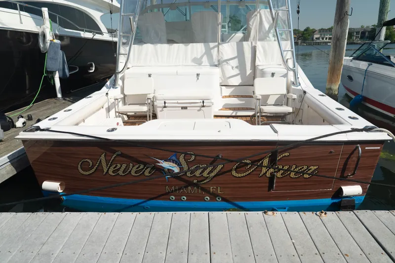 Slide: The Image of 2009 Cabo 40 Express boat docked, named "Never Say Never," Miami, FL. - 8