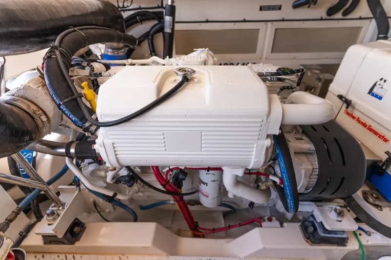Slide: The Image of Engine room of a 2009 Cabo 40 Express boat, showcasing detailed machinery components. - 49