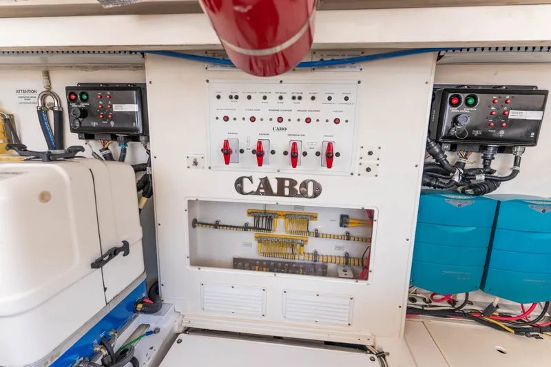 Slide: The Image of Electrical control panel of a 2009 Cabo 40 Express boat, featuring wiring and switches. - 55