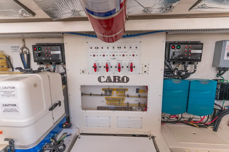 Slide: The Image of Electrical control panel of a 2009 Cabo 40 Express boat, featuring various switches and wiring. - 46