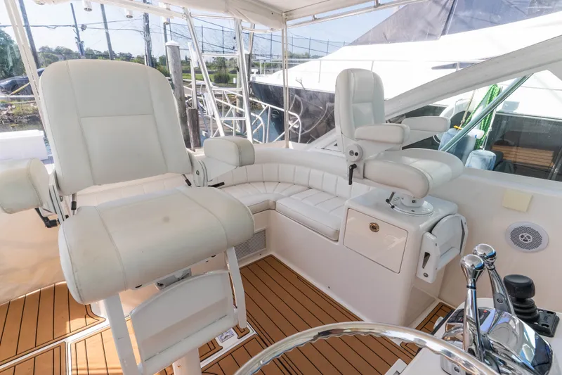 Slide: The Image of Luxurious 2009 Cabo 40 Express yacht cockpit with white seating and teak flooring. - 14