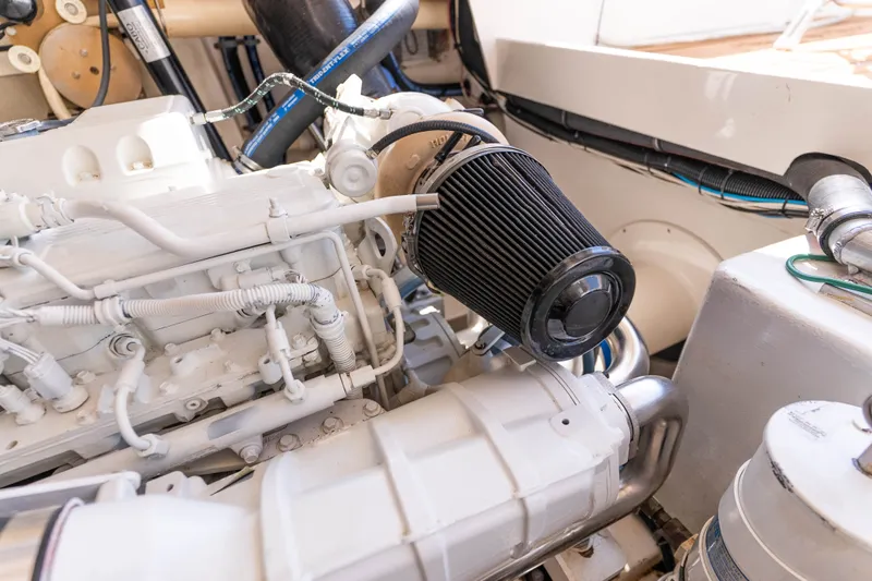 Slide: The Image of Engine compartment of a 2009 Cabo 40 Express boat, showcasing detailed mechanical components. - 52