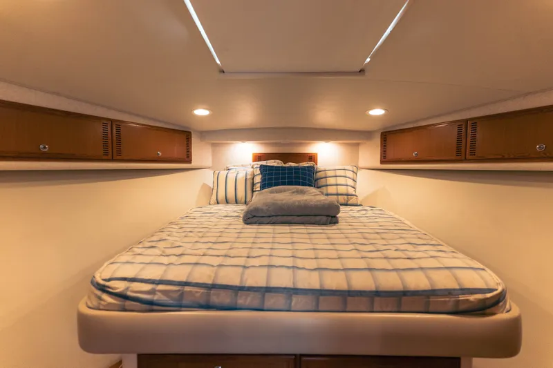Slide: The Image of Cozy cabin interior of 2009 Cabo 40 Express yacht with comfortable bedding. - 32