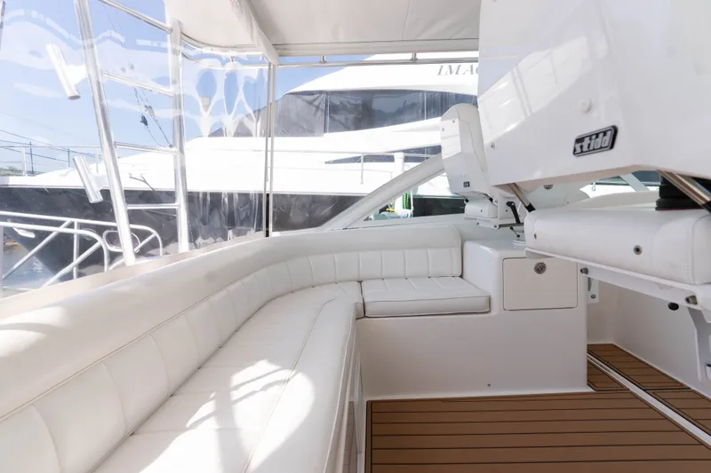 Slide: The Image of Luxurious interior of 2009 Cabo 40 Express yacht with white seating and wooden flooring. - 17