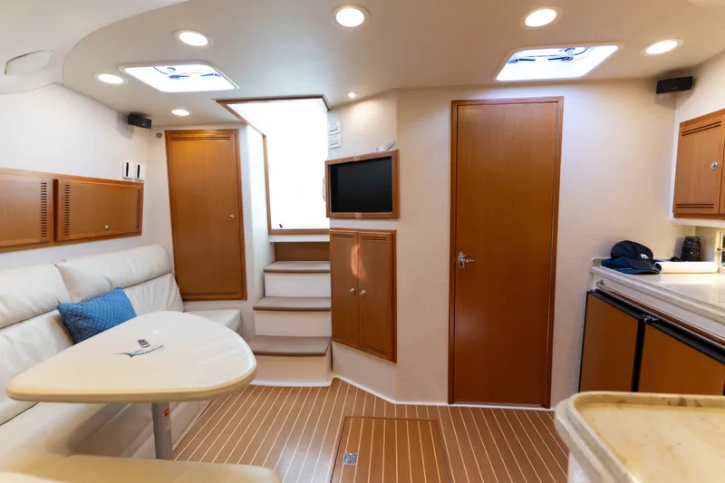 Slide: The Image of Luxurious interior of a 2009 Cabo 40 Express yacht with modern amenities and wood finishes. - 34