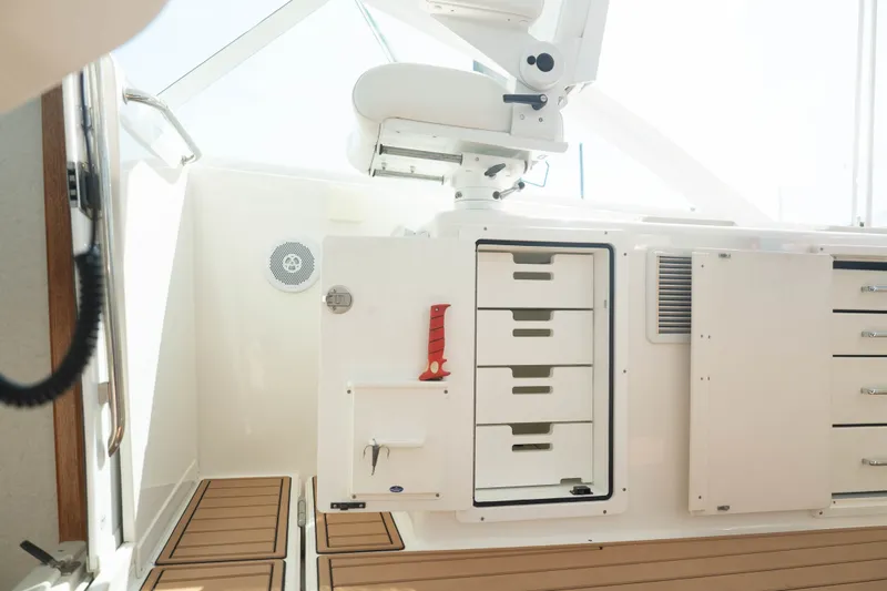 Slide: The Image of 2009 Cabo 40 Express boat interior with storage drawers and seating. - 41