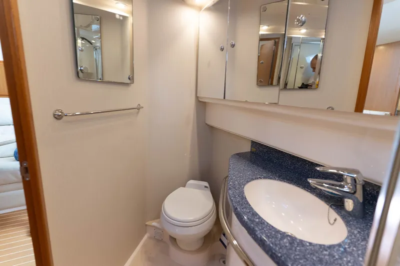 Slide: The Image of Luxurious bathroom in 2009 Cabo 40 Express yacht with modern fixtures and elegant design. - 40