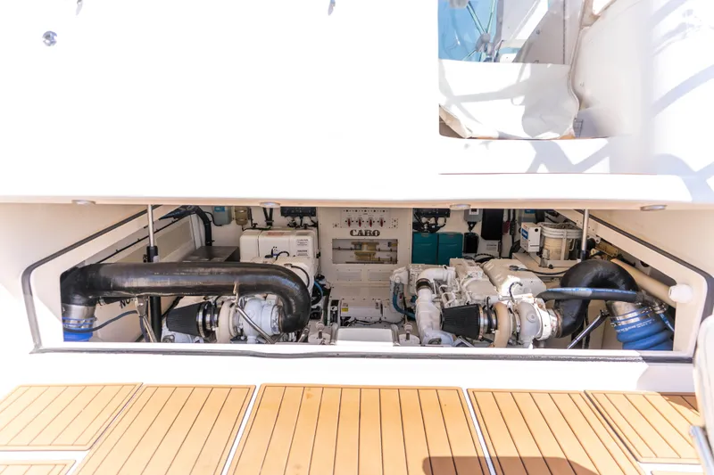 Slide: The Image of Engine compartment of 2009 Cabo 40 Express yacht, showcasing mechanical components and systems. - 57
