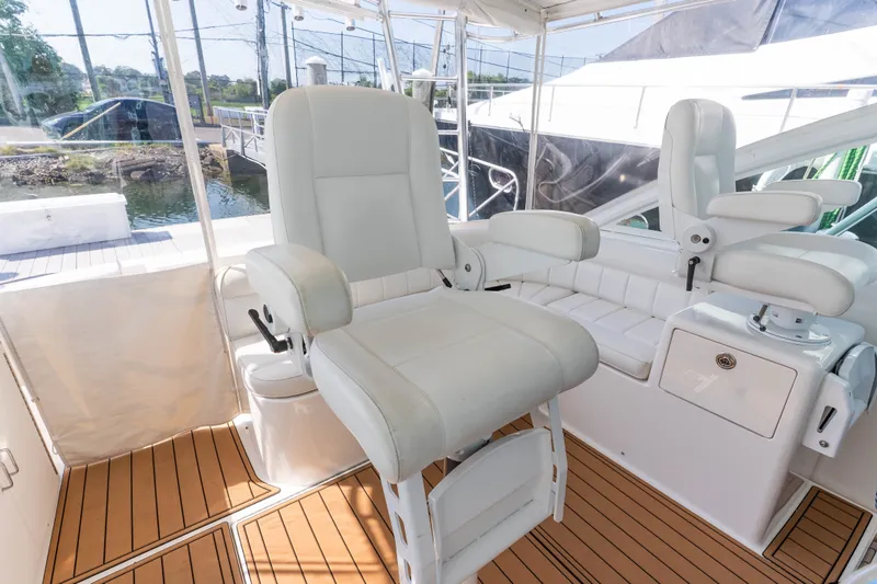 Slide: The Image of Luxurious 2009 Cabo 40 Express yacht interior with plush white seating and teak flooring. - 16