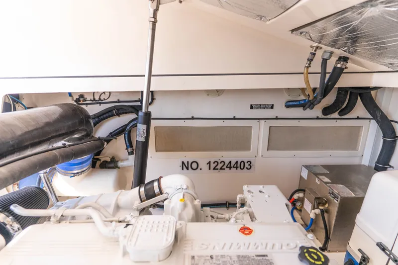 Slide: The Image of Engine room of 2009 Cabo 40 Express boat with visible equipment and serial number. - 48