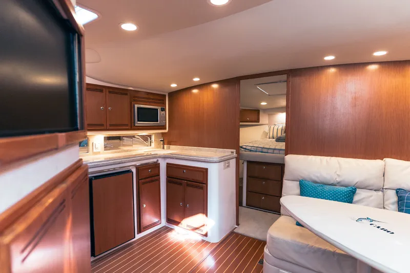 Slide: The Image of Luxurious interior of 2009 Cabo 40 Express yacht with modern kitchen and cozy seating area. - 31