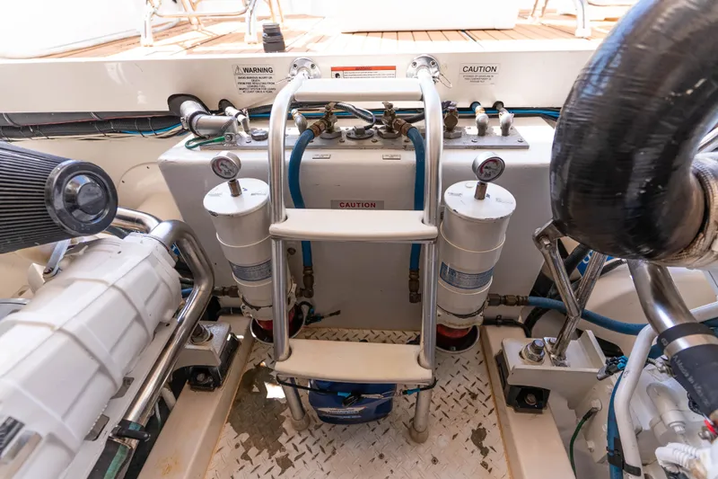 Slide: The Image of Engine room of 2009 Cabo 40 Express yacht with visible filters and piping. - 51
