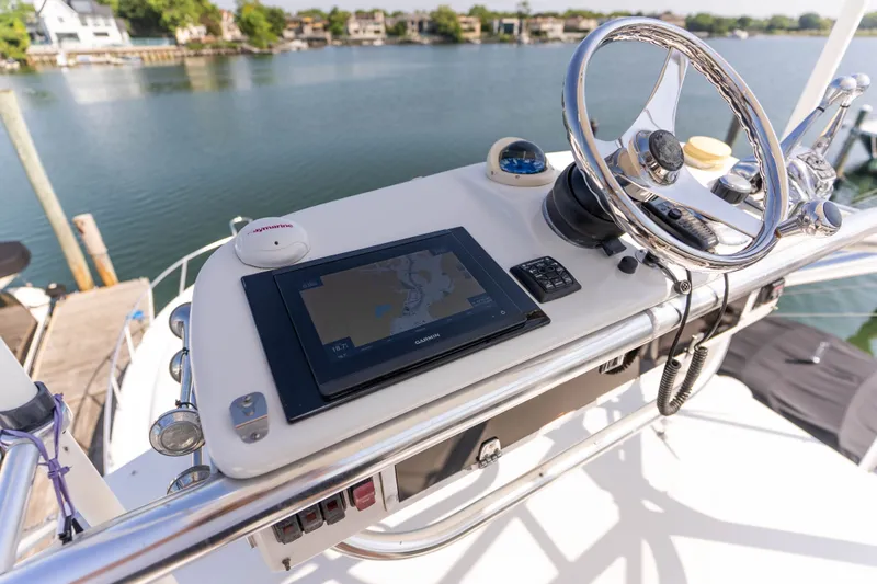 Slide: The Image of Helm of 2009 Cabo 40 Express yacht with navigation equipment and steering wheel. - 24