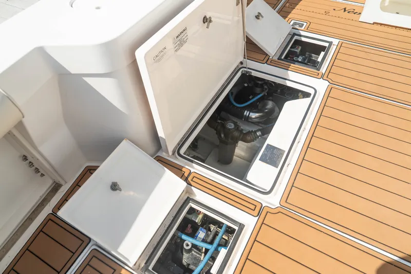 Slide: The Image of Open engine compartments on 2009 Cabo 40 Express boat deck, showcasing mechanical components. - 45