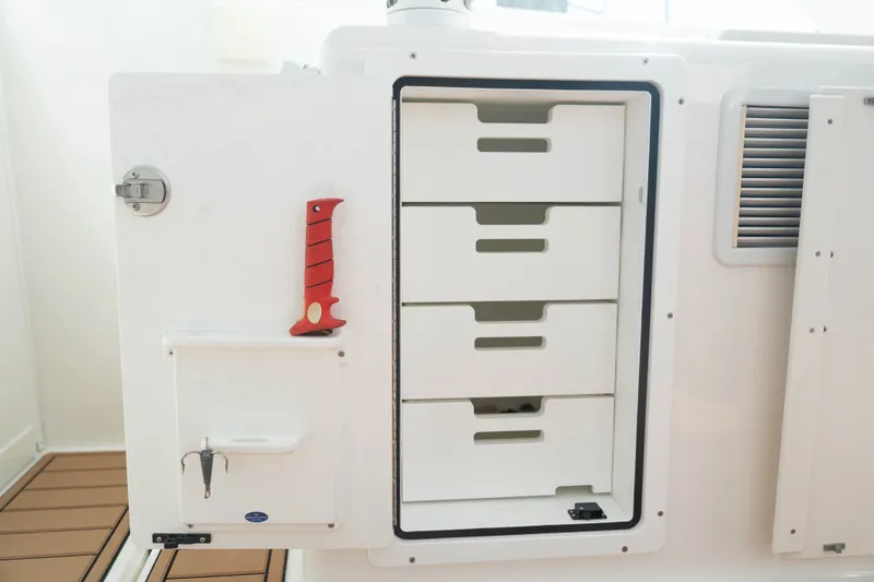 Slide: The Image of Storage compartment with drawers on a 2009 Cabo 40 Express boat. - 42