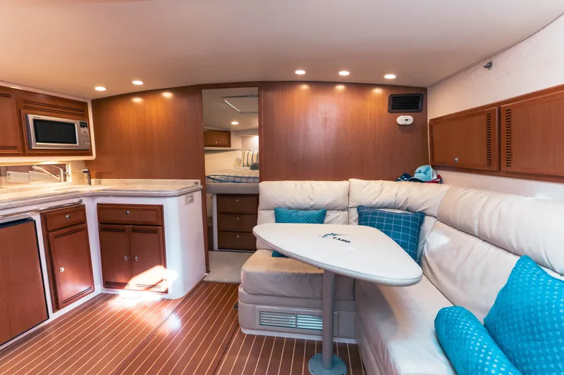 Slide: The Image of Luxurious interior of 2009 Cabo 40 Express yacht with kitchen and seating area. - 2