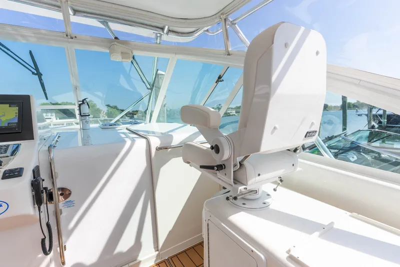 Slide: The Image of Helm of 2009 Cabo 40 Express yacht with captain's chair and navigation equipment. - 11