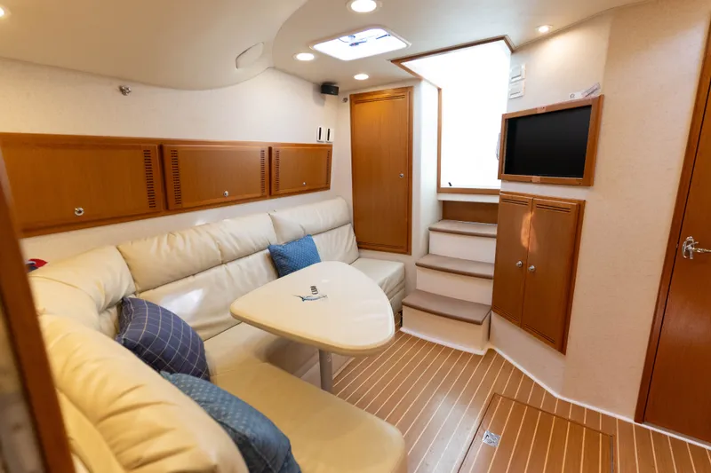 Slide: The Image of Luxurious interior of a 2009 Cabo 40 Express yacht with cozy seating and modern amenities. - 30