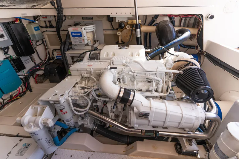 Slide: The Image of Engine room of a 2009 Cabo 40 Express boat, showcasing detailed mechanical components. - 53