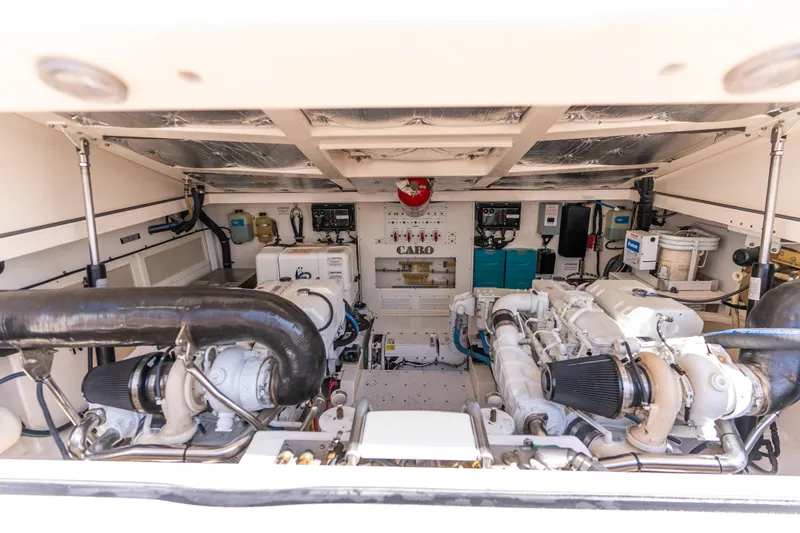 Slide: The Image of Engine room of a 2009 Cabo 40 Express boat, showcasing dual engines and mechanical systems. - 3