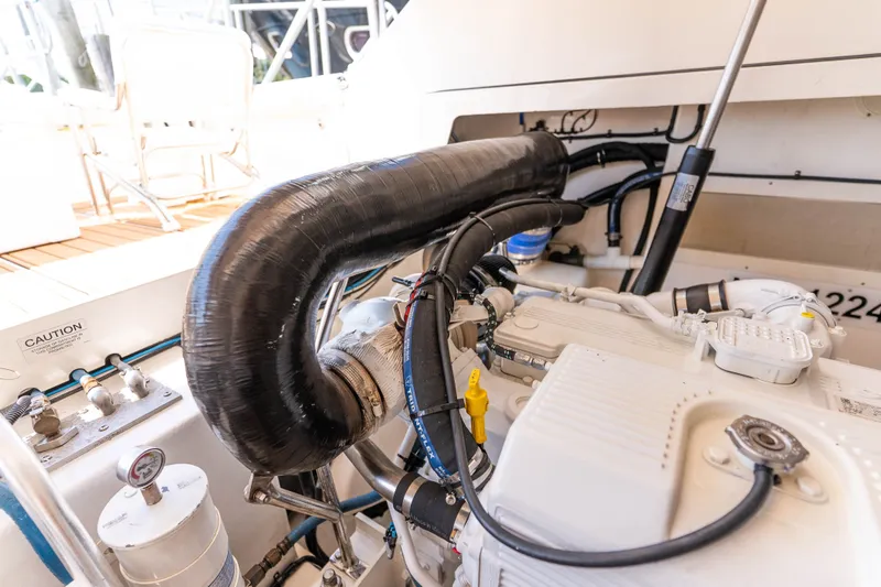 Slide: The Image of Engine compartment of a 2009 Cabo 40 Express boat, showcasing detailed mechanical components. - 50