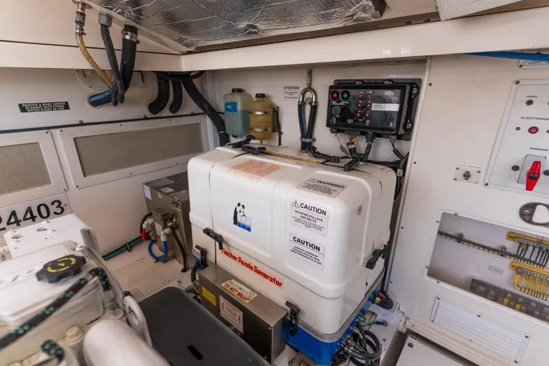 Slide: The Image of Engine room of 2009 Cabo 40 Express with Fischer Panda generator and control panel. - 47