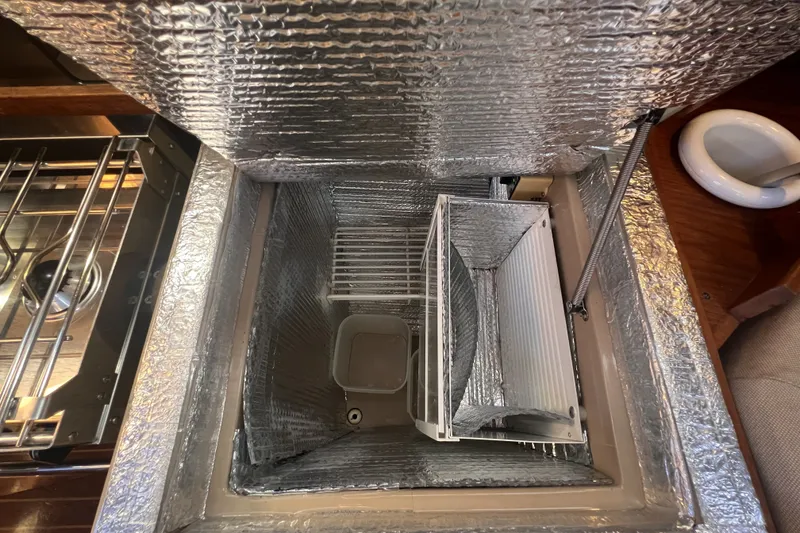 Slide: The Image of Insulated storage compartment on a 1989 C&C 30 MKII sailboat, featuring metallic lining. - 69