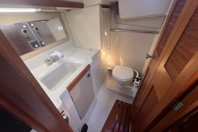Slide: The Image of 1989 C&C 30 MKII yacht bathroom with sink, toilet, and wooden accents. - 46