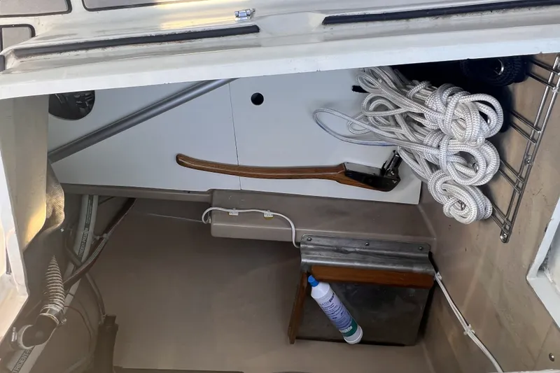 Slide: The Image of Interior view of a 1989 C&C 30 MKII sailboat showing storage area with ropes and equipment. - 81