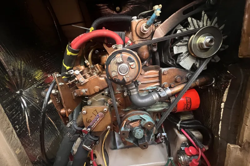 Slide: The Image of 1989 C&C 30 MKII engine compartment with visible belts and components. - 84