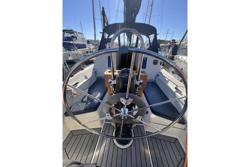 Slide: The Image of 1989 C&C 30 MKII sailboat cockpit with steering wheel, docked at marina. - 33