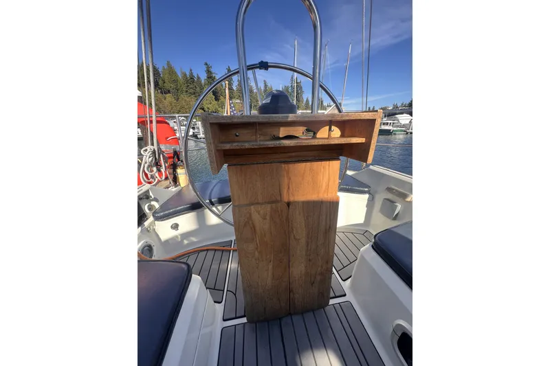 Slide: The Image of Cockpit of 1989 C&C 30 MKII sailboat with wooden helm and scenic marina view. - 32