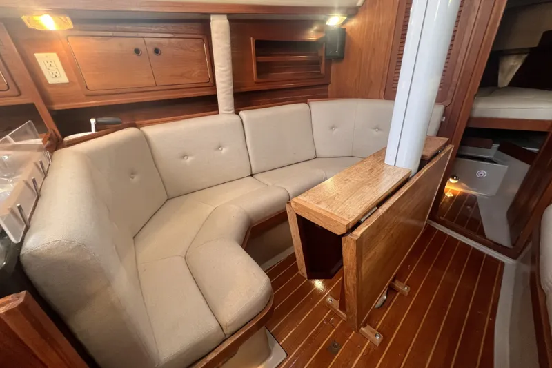 Slide: The Image of Interior of 1989 C&C 30 MKII sailboat with cozy seating and wooden table. - 76