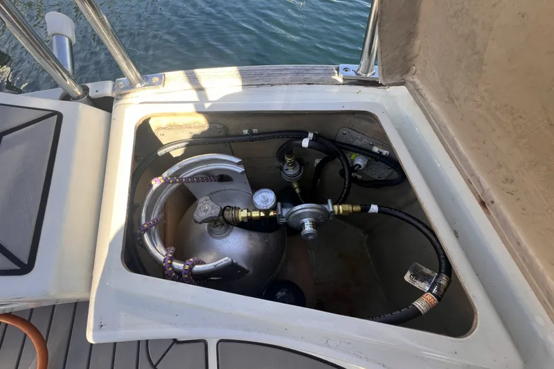 Slide: The Image of Propane tank storage on 1989 C&C 30 MKII sailboat, with hoses and regulator visible. - 39