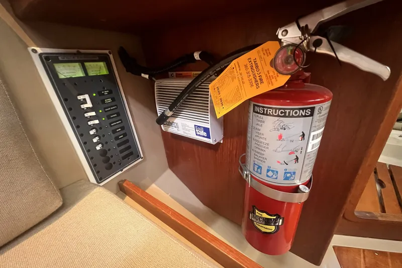Slide: The Image of Electrical panel and fire extinguisher inside a 1989 C&C 30 MKII sailboat cabin. - 57