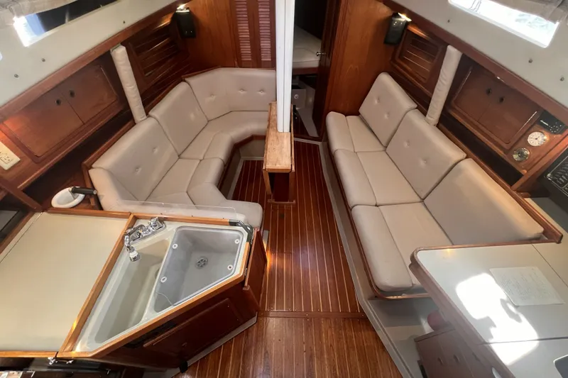 Slide: The Image of Interior of 1989 C&C 30 MKII sailboat with cozy seating and wooden finishes. - 44
