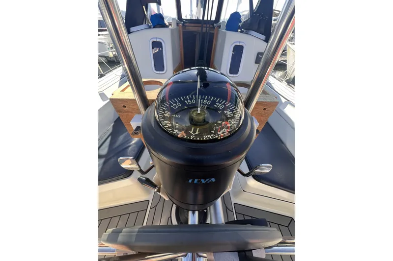 Slide: The Image of Compass on 1989 C&C 30 MKII sailboat cockpit, showcasing navigation equipment. - 34